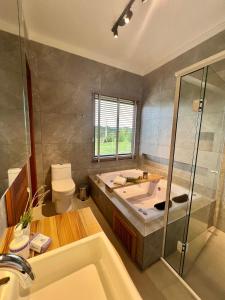 a bathroom with a tub and a toilet and a sink at Sion Vivendas da Serra in Urubici +70 photos