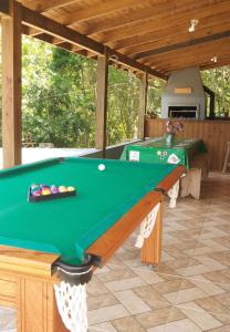 a pool table in a pavilion in a house at CABANA PARAÍSO in Santo Amaro da Imperatriz