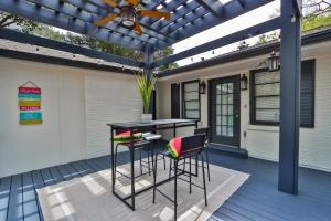 a patio with a table and stools under a pergola at Heart Of Buckhead5bed 5 Bath in Atlanta