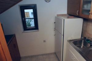 a kitchen with a refrigerator and a sink and a window at Apartments with parking space Cavtat, Dubrovnik - 2132 in Cavtat