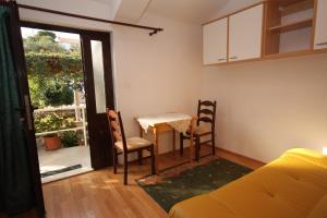 a living room with a table and two chairs at Apartments and rooms by the sea Zaton Veliki, Dubrovnik - 2110 in Zaton