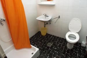 an orange shower curtain in a bathroom with a toilet and sink at Rooms with WiFi Lopud, Elafiti - 2169 in Lopud