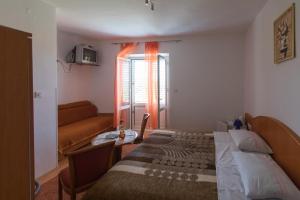 a bedroom with a bed and a couch and a window at Rooms with WiFi Lopud, Elafiti - 2169 in Lopud Island +10 photos