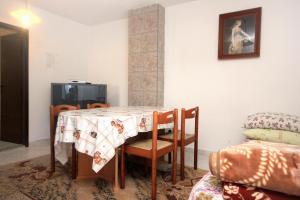 a dining room with a table and a tv at Apartments with a parking space Peroj, Fazana - 2234 in Peroj