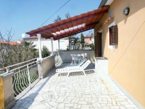 a patio with two white chairs and a table at Rooms with a parking space Rovinj - 2245 in Rovinj