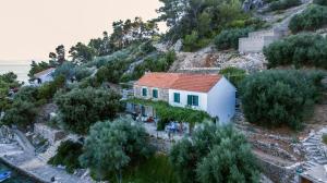 a house on the side of a mountain at Seaside secluded apartments Cove Torac, Hvar - 4044 in Gdinj