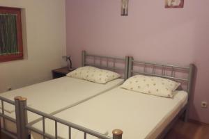two twin beds in a room with a window at Apartments with a parking space Mudri Dolac, Hvar - 4043 in Vrbanj