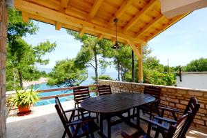 a table and chairs on a patio with a view of the water at Apartments by the sea Mudri Dolac, Hvar - 4026 in Vrboska