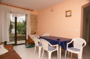 a dining room with a blue table and white chairs at Apartments with parking space Jelsa, Hvar - 4040 in Jelsa