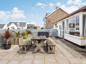 a picnic table on the patio of a house at Halcyon in Tintagel
