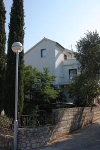 a white house with a street light in front of it at Apartments with a parking space Stari Grad, Hvar - 4014 in Stari Grad