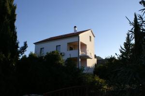 a white building with a balcony on top of it at Apartments with a parking space Stari Grad, Hvar - 4014 in Stari Grad