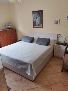 a bedroom with a bed with blue pillows on it at Apartments with a parking space Metajna, Pag - 4127 in Zubovići