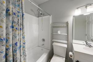 a bathroom with a shower and a toilet and a sink at The Secluded Secret in Stone Mountain in Stone Mountain