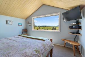 a bedroom with a bed and a window at Delightful 1-bed barn with stunning mountain views... in Cave