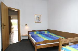 a bedroom with a bed with blue and yellow pillows at Apartment Mandre 4098d in Mandre