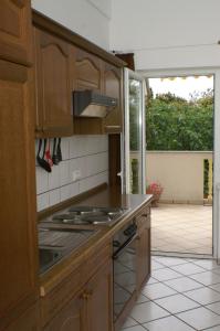 a kitchen with wooden cabinets and a stove top oven at Apartment Mandre 4098d in Mandre