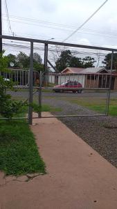 a fence in front of a building with a train at Apartamento La Fortuna #2 in Fortuna +5 photos