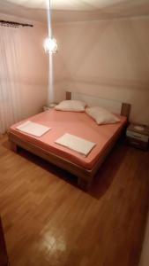 ein Bett mit zwei Kissen in der Unterkunft Apartment Metajna 4150b in Metajna