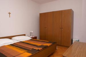 a bedroom with a bed and a wooden cabinet at Double Room Mulobedanj 4061a in Lun