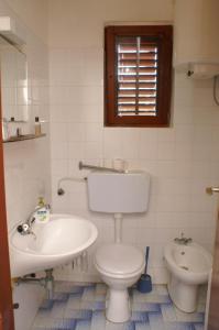 a white bathroom with a toilet and a sink at Double Room Mulobedanj 4061a in Lun
