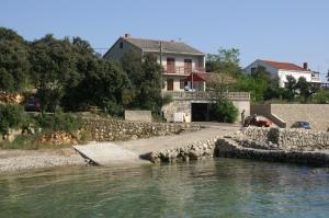 a house next to a river with a building at Rooms by the sea Cove Mulobedanj, Pag - 4061 in Lun