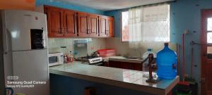 a kitchen with a white refrigerator and a sink at Puerto Lucía - Salinas Beach in Salinas
