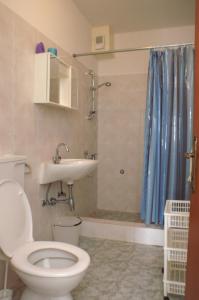 a bathroom with a toilet and a sink and a shower at Apartment Novalja 4114a in Novalja