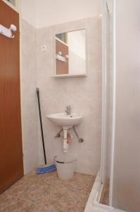 een badkamer met een wastafel en een douche bij Apartment Novalja 4114d in Novalja
