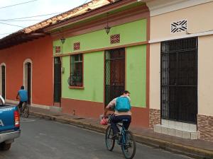 a person riding a bike down a street at Casa Silas Granada Nicaragua in Granada