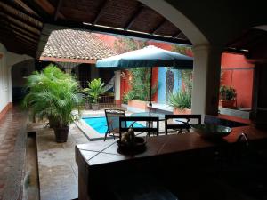 a patio with a table and chairs and a pool at Casa Silas Granada Nicaragua in Granada