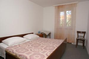 una camera da letto con un letto, una finestra e una sedia di Apartments with parking space Vodice - 4192 a Vodice