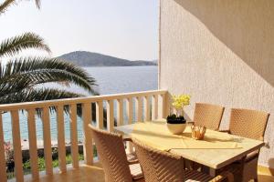 a table and chairs on a balcony with the ocean at Apartments by the sea Razanj, Rogoznica - 4253 in Ražanj