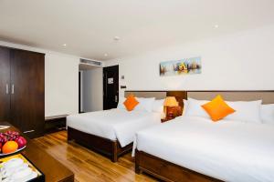 Postel nebo postele na pokoji v ubytování Roliva Hotel & Apartment Danang