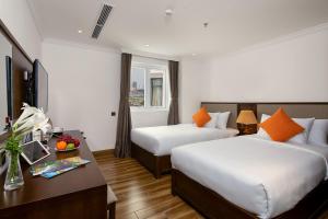 Postel nebo postele na pokoji v ubytování Roliva Hotel & Apartment Danang