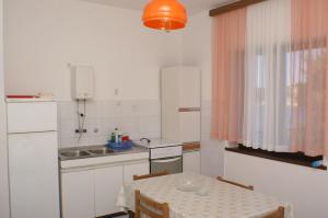 a small kitchen with a table and a sink at Apartment Bilo 4189a in Podgreben