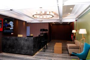 a lobby with a bar and a couch at Golden Roof Hotel, Seri Iskandar in Seri Iskandar