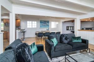 a living room with a couch and a dining room at 4 Bedroom house large pool & spa in prime location in Los Angeles