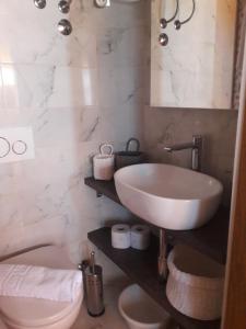 a bathroom with a sink and a toilet at Apartments and rooms by the sea Sumpetar, Omis - 2099 in Jesenice