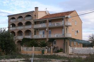 a large brick building with balconies on it at Apartments and rooms with parking space Biograd na Moru, Biograd - 4305 in Biograd na Moru