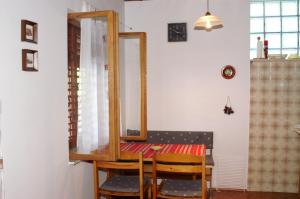 a dining room with a table and a mirror at Apartments by the sea Nemira, Omis - 4277 in Tice