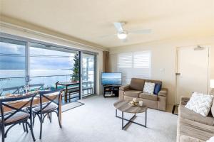 a living room with a couch and a table at Shoal Towers, 6 -11 Shoal Bay Rd - Air Conditiong - Wifi - Stunning water views & perfect location in Shoal Bay