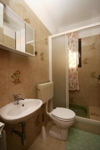 a bathroom with a toilet and a sink at Apartments by the sea Slatine, Ciovo - 1137 in Slatine