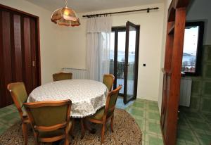 a dining room with a table and chairs and a window at Apartments by the sea Slatine, Ciovo - 1137 in Slatine
