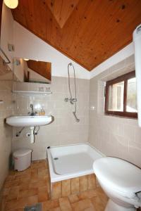 a bathroom with a tub and a sink and a toilet at Rooms by the sea Sladjenovici, Dubrovnik - 2161 in Slano