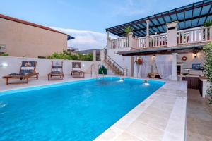 a swimming pool in the backyard of a house at Seaside apartments with a swimming pool Jelsa, Hvar - 2067 in Jelsa
