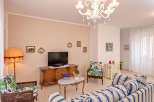 a living room with couches and a flat screen tv at Seaside apartments with a swimming pool Jelsa, Hvar - 2067 in Jelsa