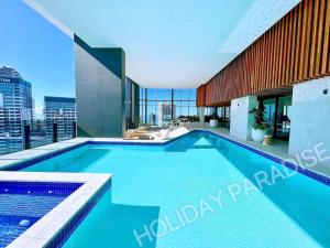 a swimming pool with a view of the city at Luxury S Casino Residences Broadbeach - Holiday Paradise in Gold Coast