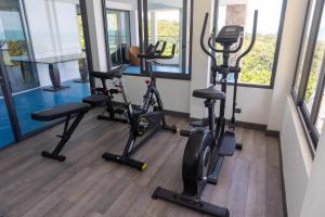 a gym with three treadmills and elliptical machines at Tropical Villa 1 in Lamai