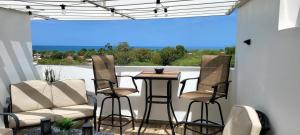 a patio with chairs and a table and a window at Villa Marlyn in Cabo Rojo